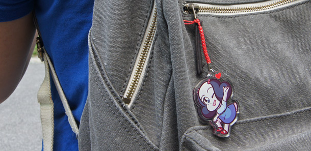 The Rachel acrylic charm on a backpack.